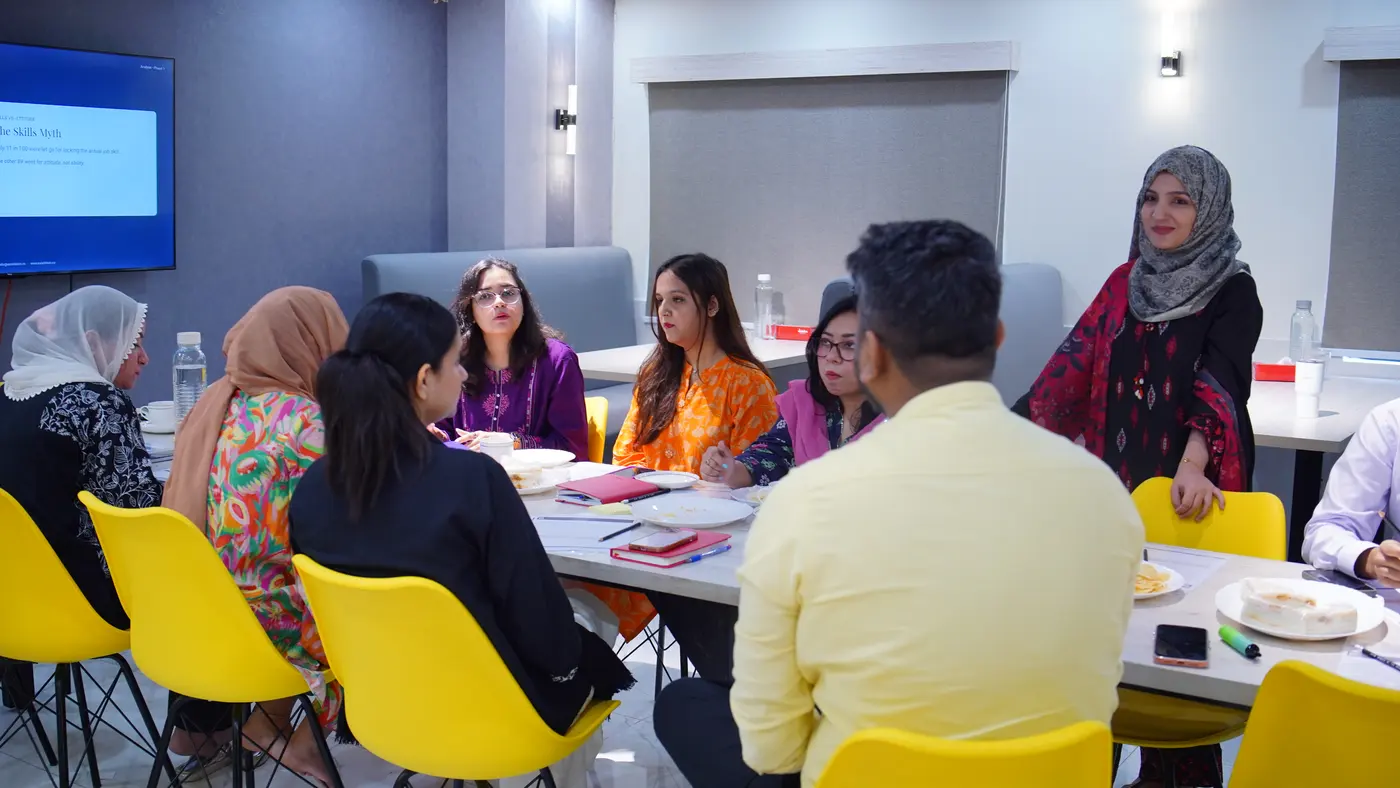 A facilitator standing as the Jubilee Life team talks around the table.